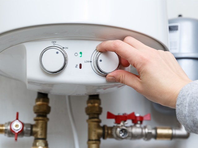 A person adjusting their boiler flow temperature