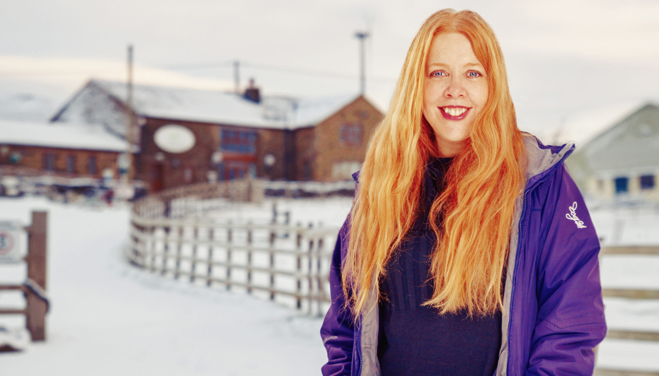 Wellbeing Farm owner, Celia Gaze, stood in front of the Wellbeing Farm on a snowy day.